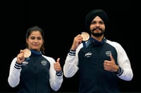 | Photo: AP/Manish Swarup : Manu Bhaker and Sarabjot Singh with their bronze medal